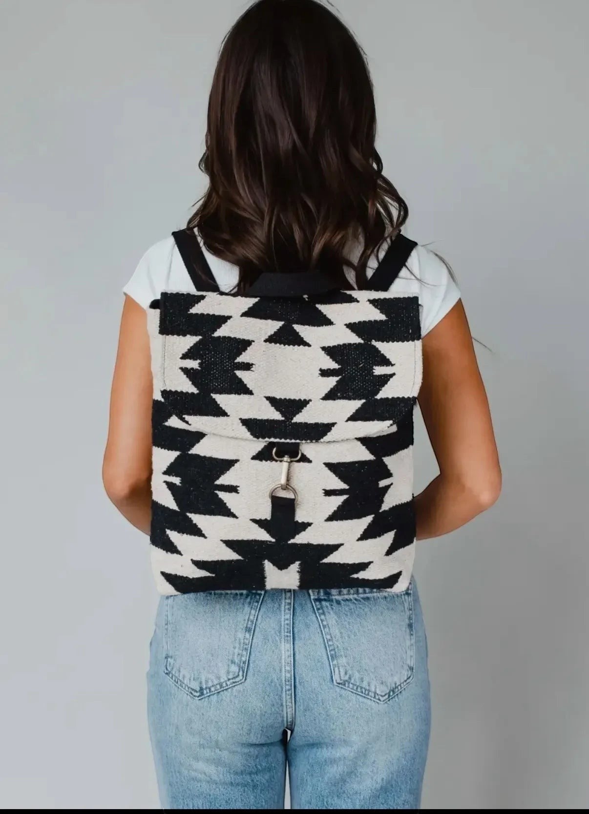 Sighthound Designs black and white geometric woven backpack with faux leather straps.